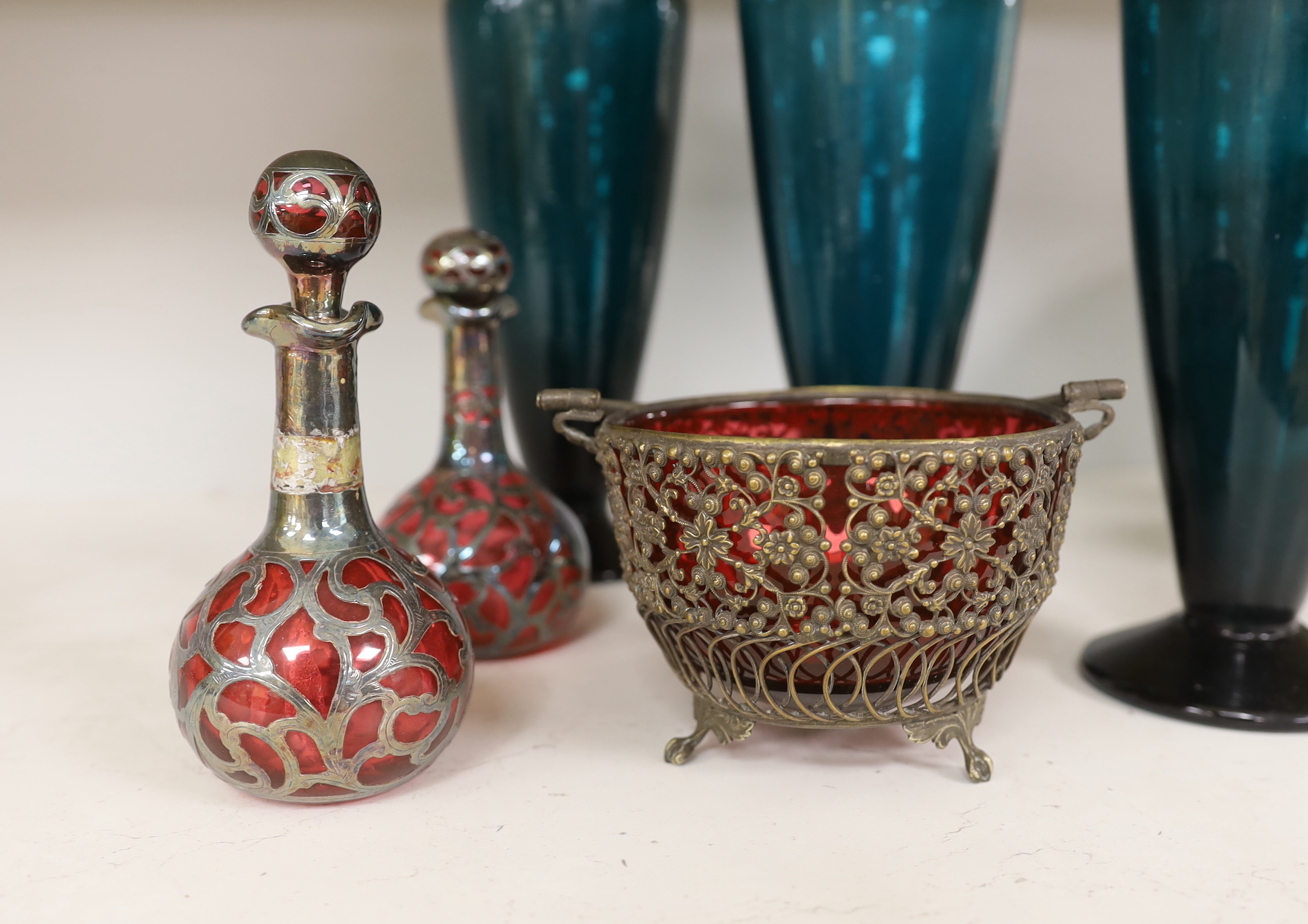 Three green glass flasks, a ruby glass basket and two overlaid ruby glass scent bottles, tallest 33cm (5)